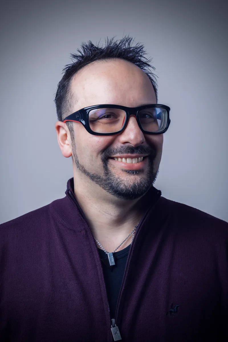 Diego Russo smiling in a studio headshot